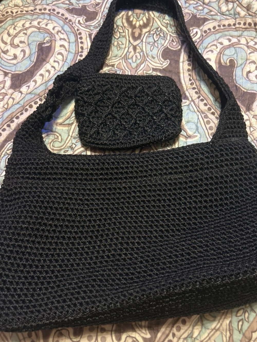 The Sak Black Woven Mini Shoulder Bag with Coin Pouch zipper attachment is mis